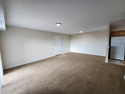 A room with a carpeted floor and a white ceiling.
