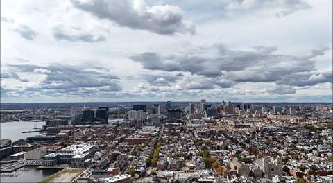 A cityscape with a cloudy sky above it.