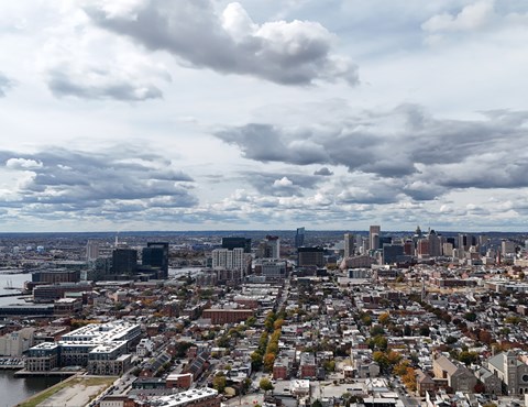 A cityscape with a cloudy sky above it.