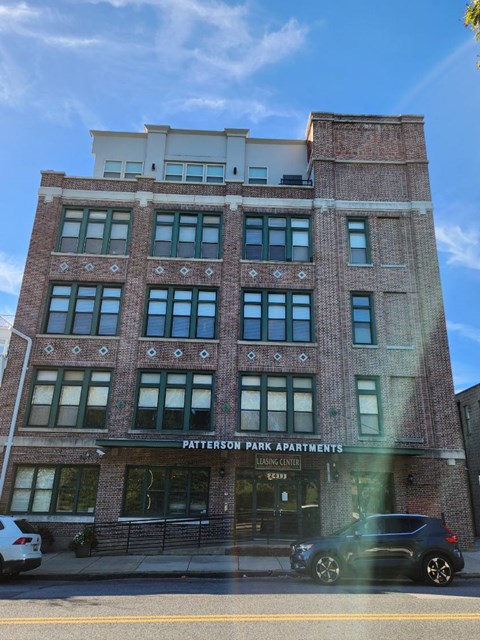 A building with the sign Patterson Park Apartments is shown.