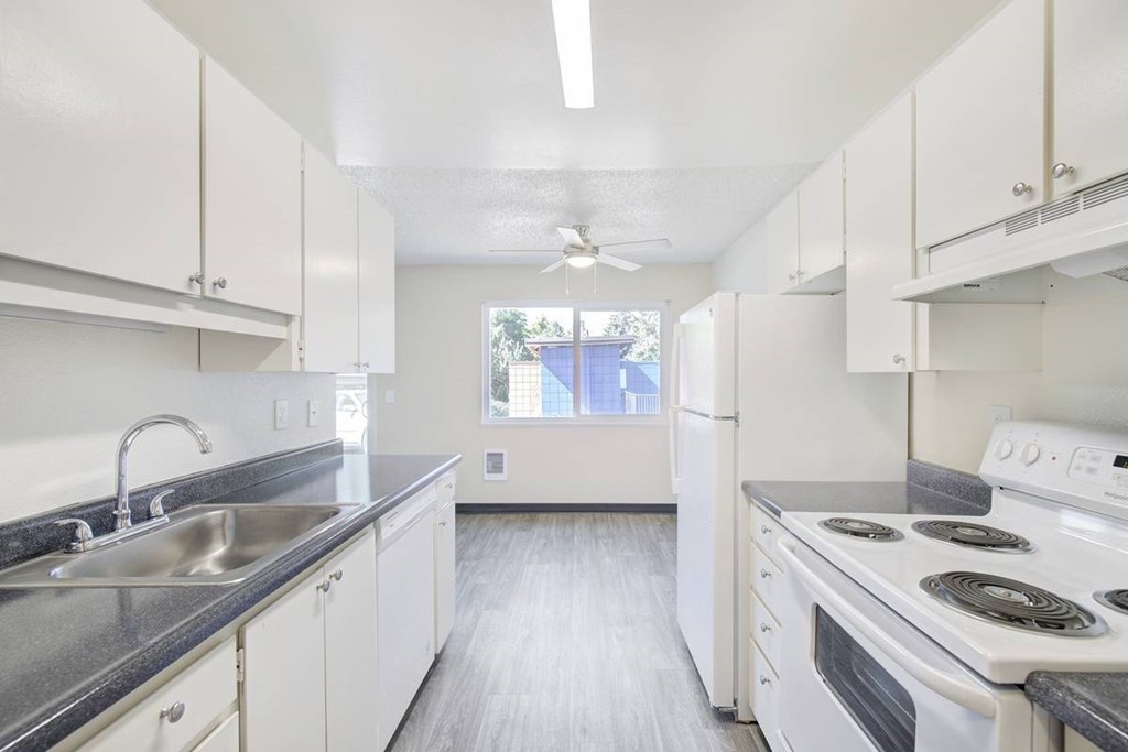 A kitchen with white appliances and cabinets A kitchen with white appliances and cabinets at Royal Pines Apartments, Beaverton 97005