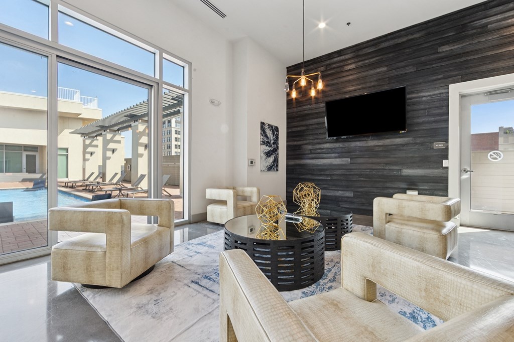 A modern living room with a flat screen TV mounted on the wall.