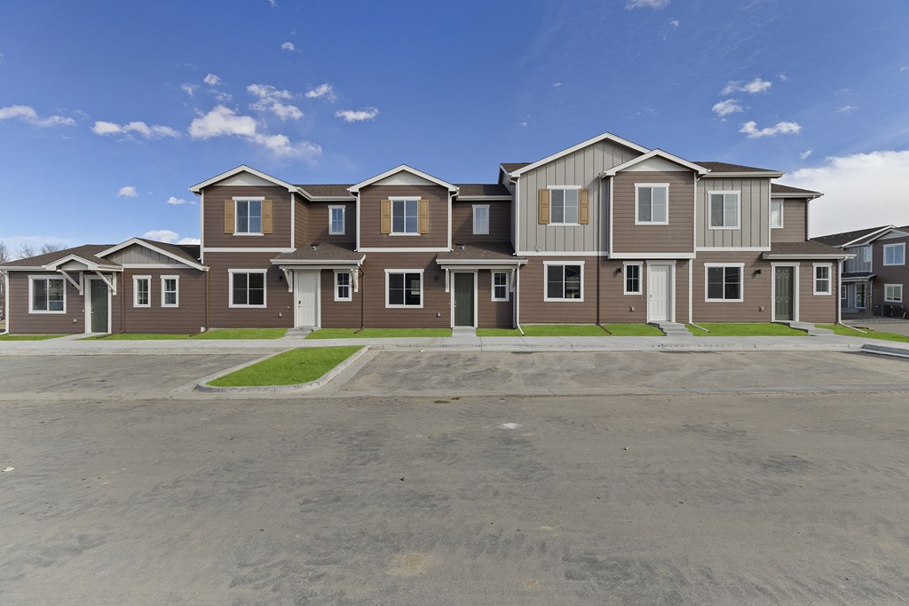an empty parking lot in front of an apartment building at Arrive Longmont, Longmont