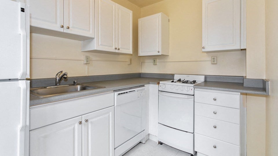a kitchen with white appliances and white cabinets