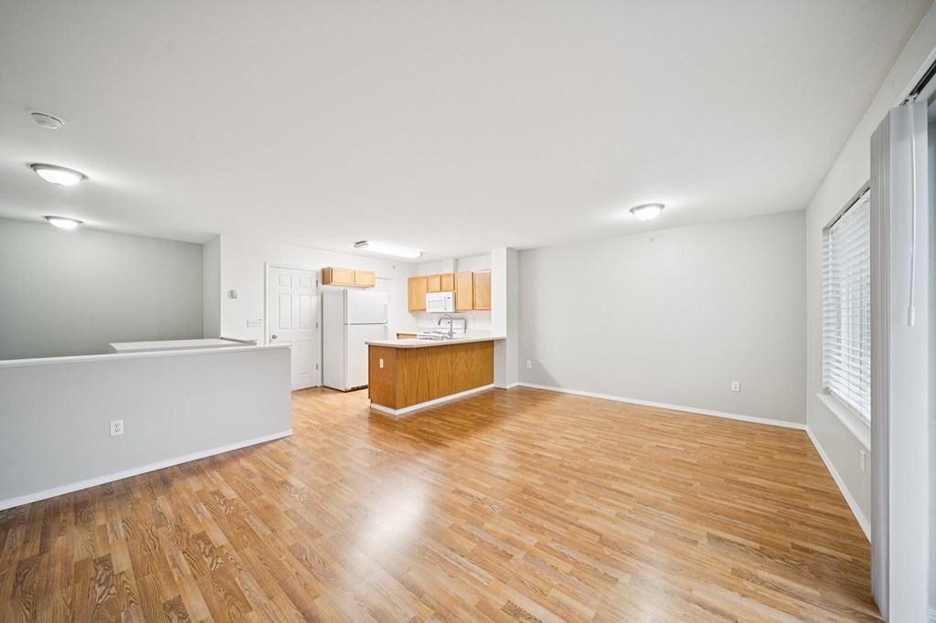 A room with wooden floors and white walls.