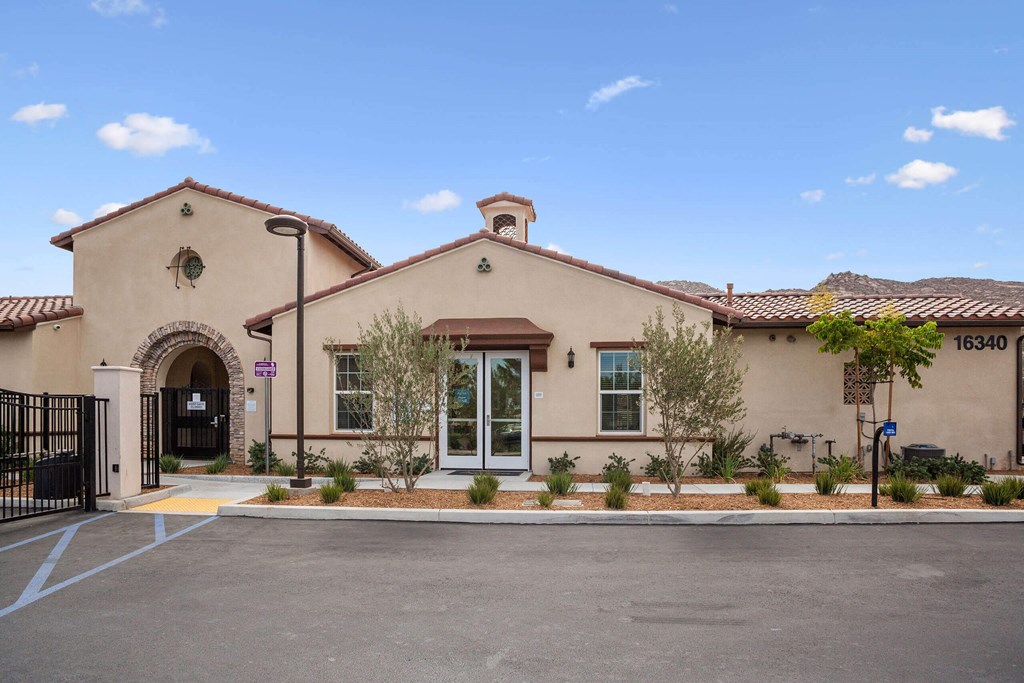 a building with a driveway and trees in front of it at Rancho Belago, Moreno Valley, CA, 92555