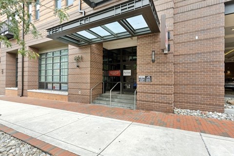 the entrance of a brick building with stairs