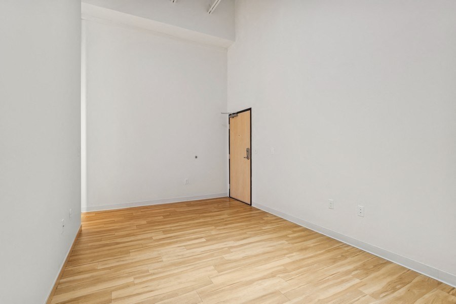 A room with a wooden floor and a door.