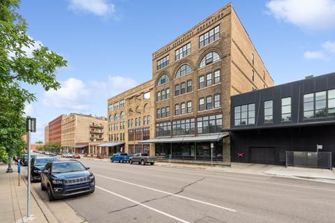 a large brick building on a city street at Gaar Scott Historic Lofts, Minnesota, 55401