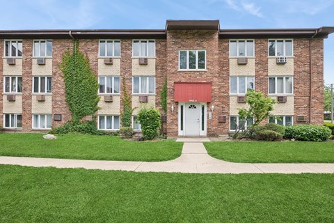 A red building with a white door and windows.