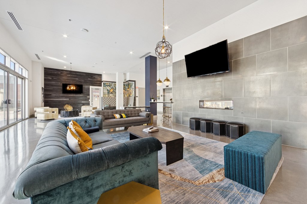 A modern living area with a blue sofa and a fireplace.