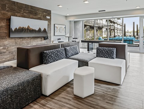 A modern living room with a grey and white sofa set.