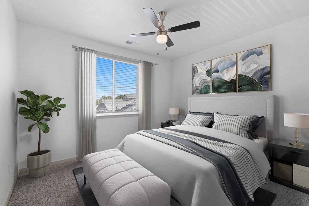 a bedroom with a white bed and a ceiling fan