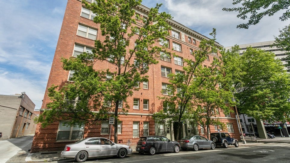 a large brick building with cars parked in front of it