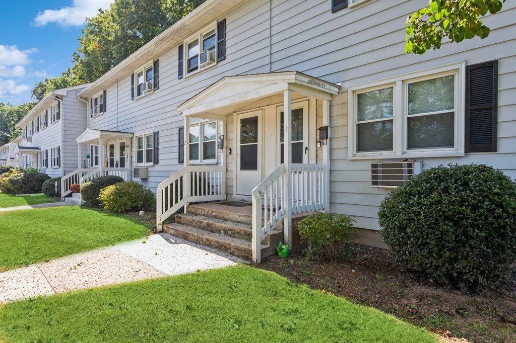 the front of a white house with a porch and a lawn at Fox Hill Commons, Connecticut