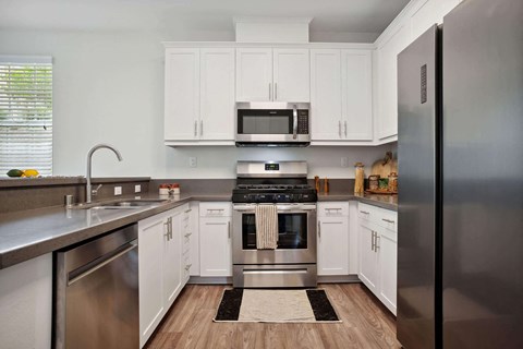 a kitchen with stainless steel appliances and white cabinets