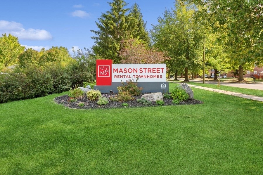 a sign in the middle of a grass field at Mason Street Townhomes, Grand Rapids, 49505