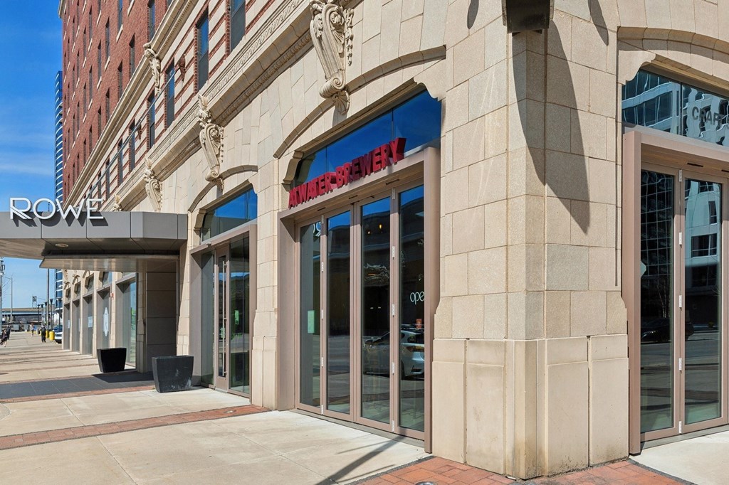 a building with a sign on the side of a street at The Rowe, Grand Rapids, MI