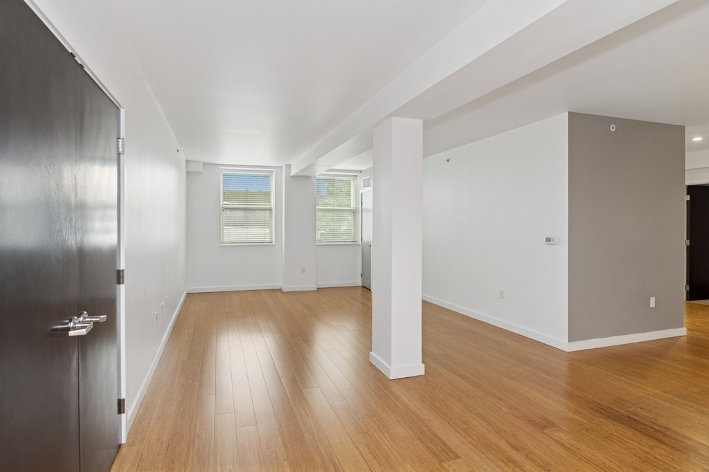 A room with wooden floors and white walls.