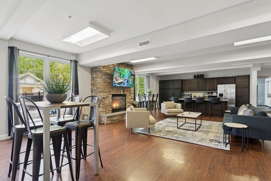 A modern living room with a fireplace and a dining table.