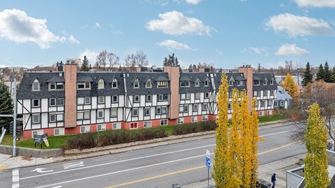 A street view of a building with a red and white facade.