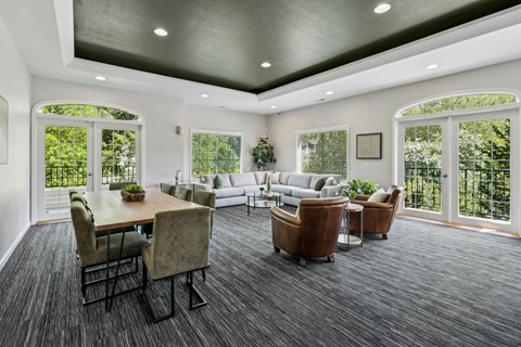 A spacious living room with a dining table and chairs.
