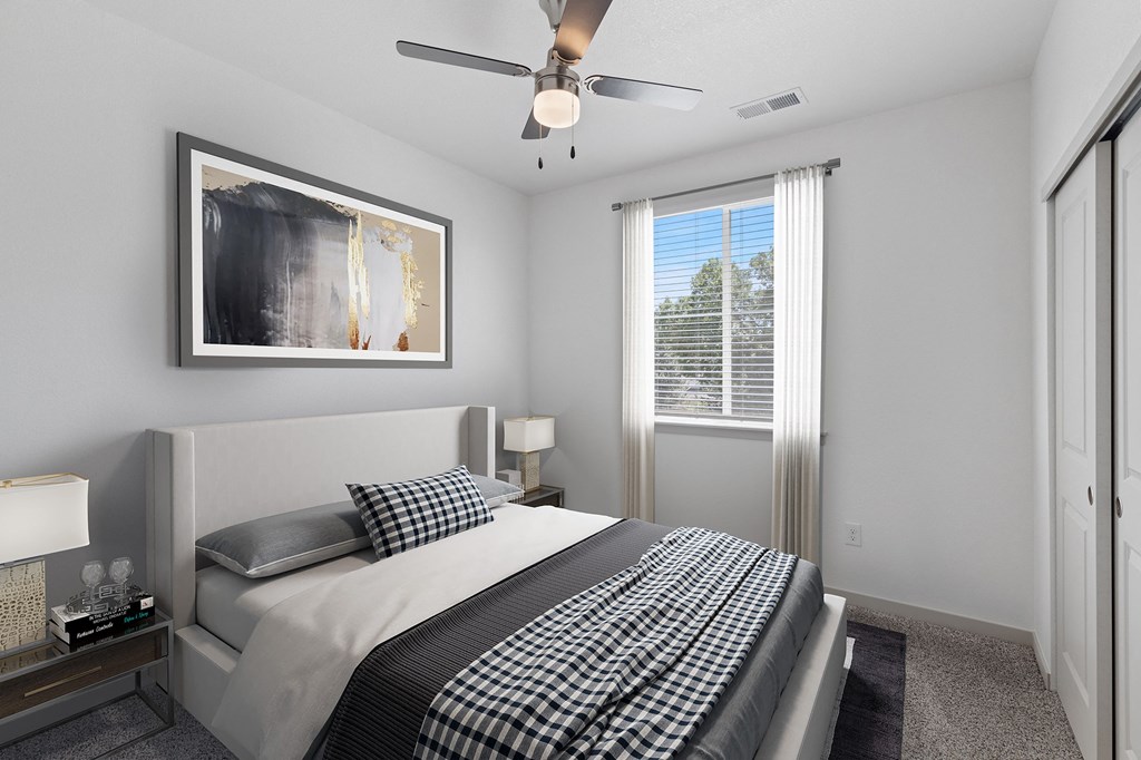 a bedroom with a bed and a ceiling fan