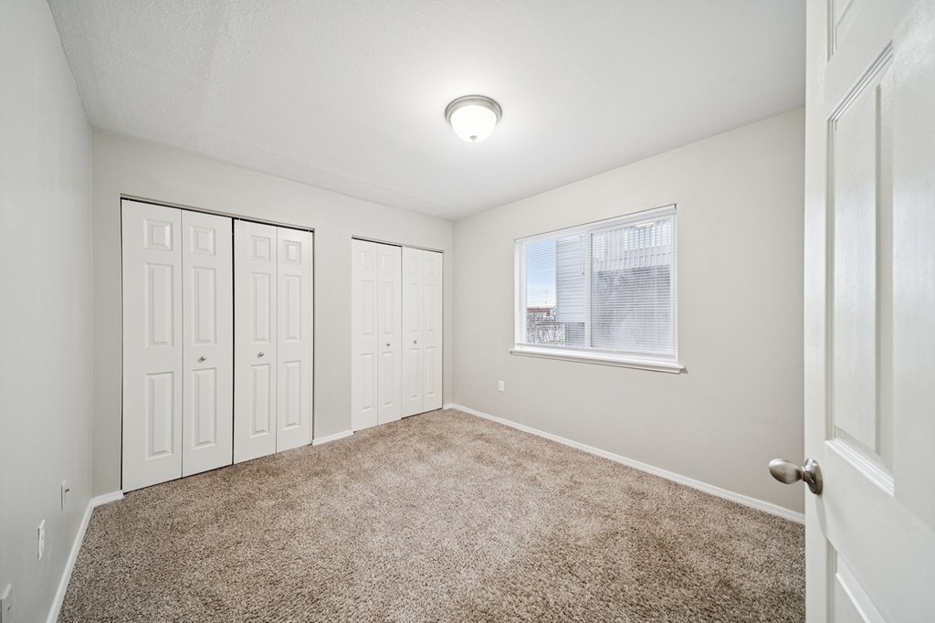 A room with white walls and a carpeted floor.