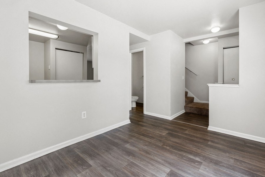 a living room with white walls and wood flooringat Mason Street Townhomes, Grand Rapids, 49505