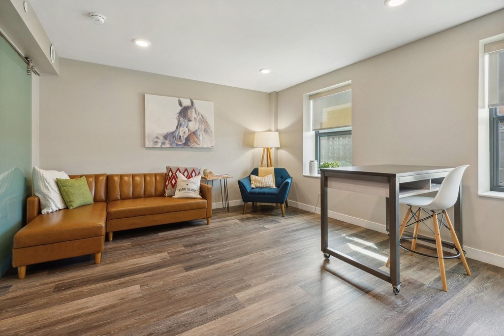 a living room with a couch and a desk at The Rowe, Grand Rapids, Michigan