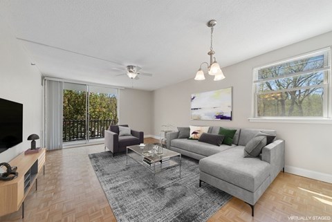 A living room with a grey couch and a coffee table.