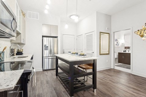 a kitchen with a large island and a refrigerator