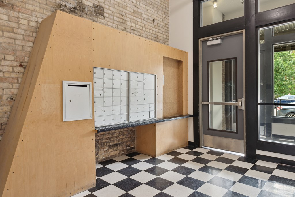 a lockers area in front of a door with a black and white checkered floorat Gaar Scott Historic Lofts, Minneapolis, 55401