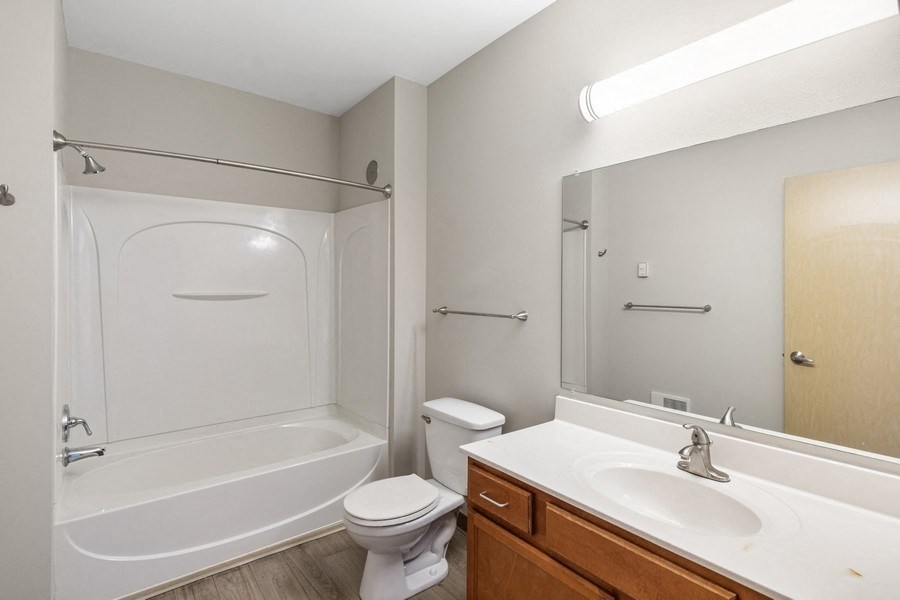 a bathroom with a shower toilet and sink and a mirror