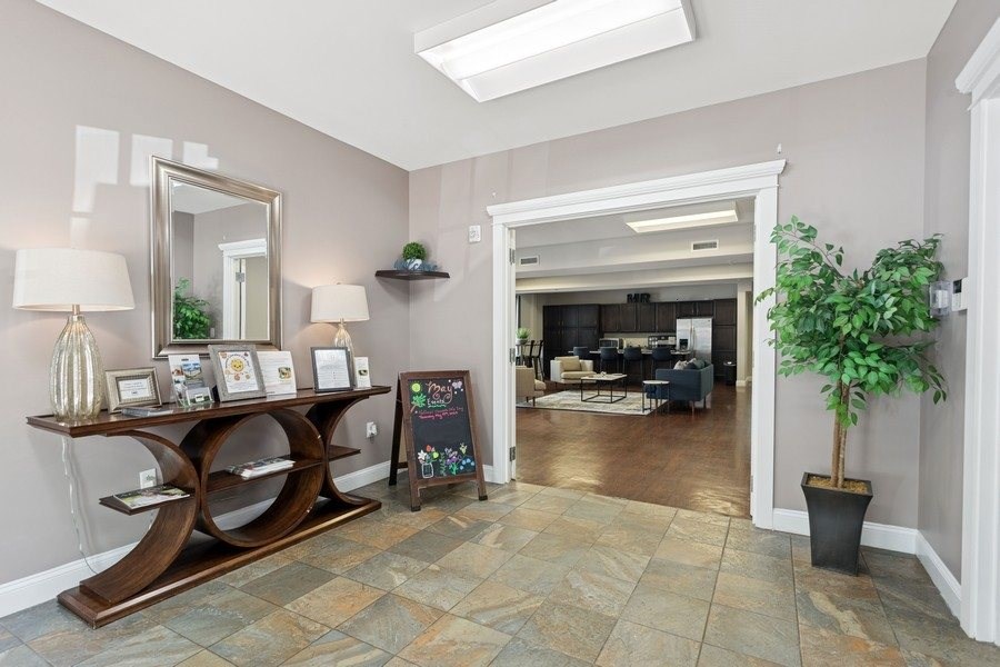 A room with a wooden table and a mirror on the wall.