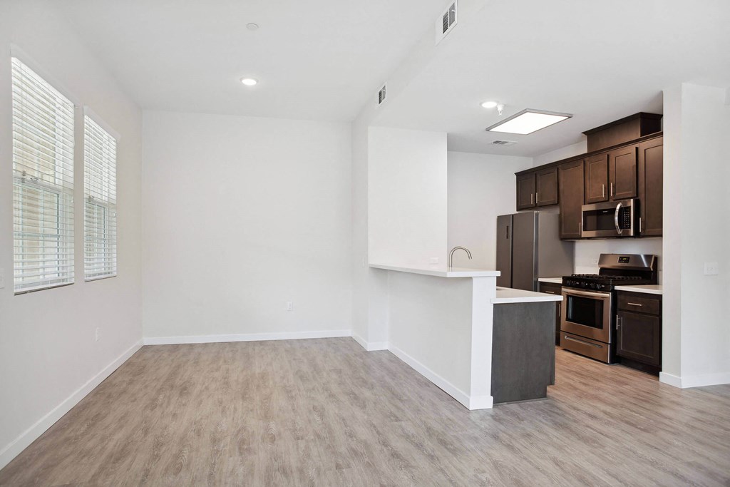 a kitchen and living room in a 555 waverly unit at Rancho Belago, Moreno Valley