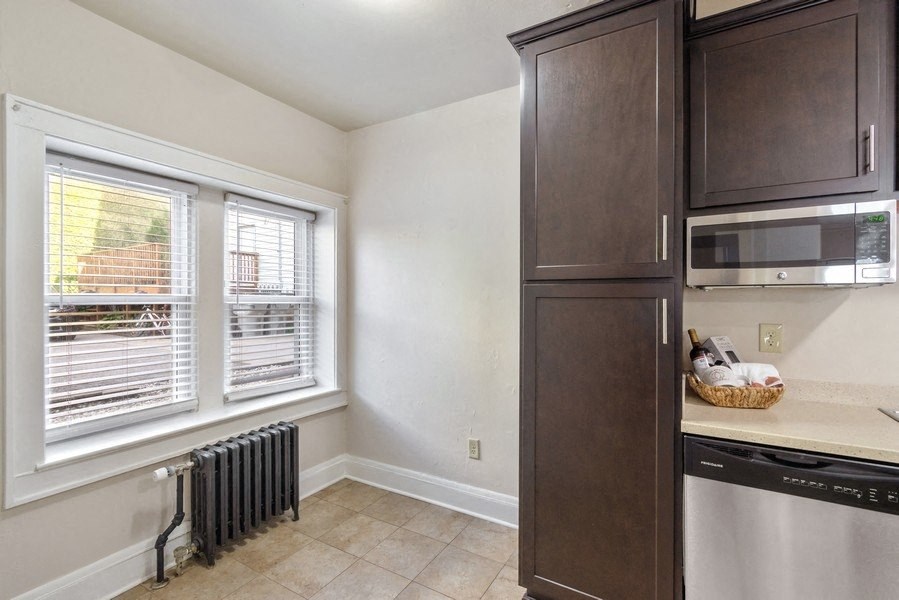 a kitchen with a dishwasher and a sink and a window