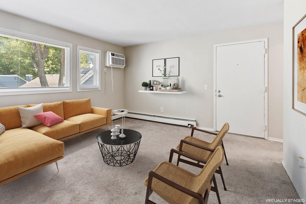 A living room with a sofa, chairs, and a coffee table.