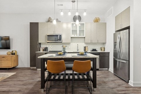 a kitchen and dining room with a table and chairs