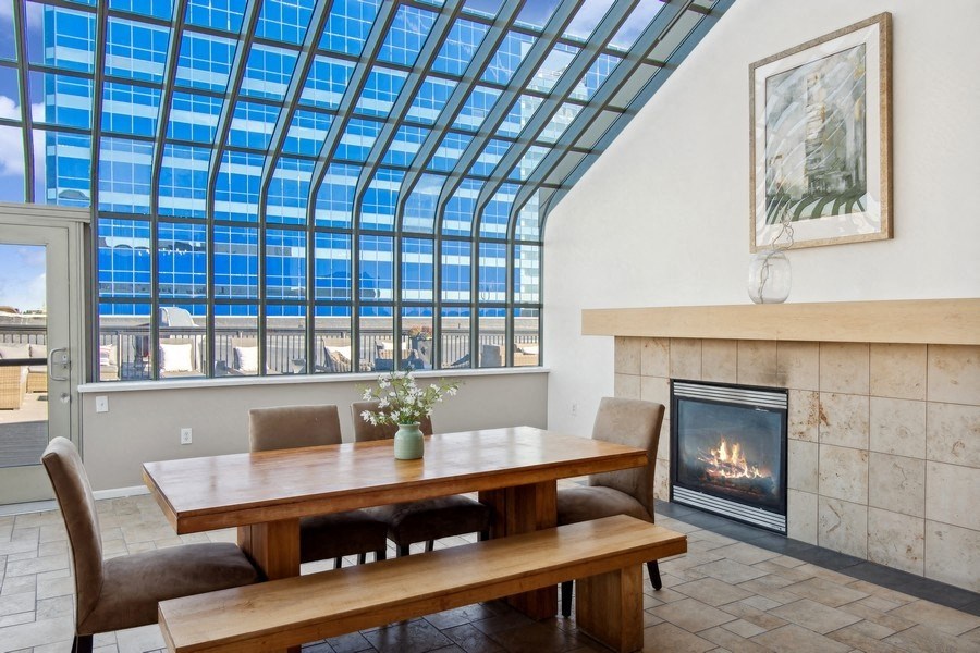 a room with a table and chairs and a fireplace