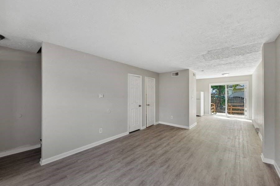 an empty living room with a door to a patioat Fort Collier Terrace, Winchester, VA