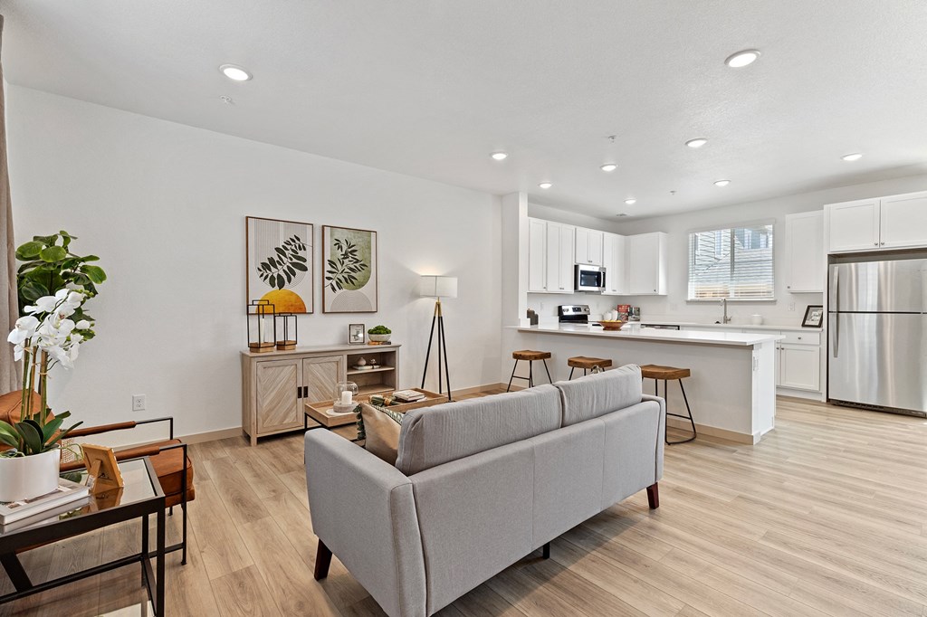 a living room with a couch and a kitchen