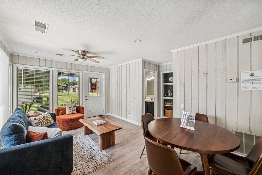 An office with a blue couch and a wooden coffee table.