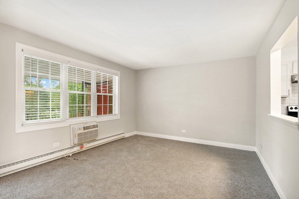 a bedroom with two windows and an air conditioner at The Hinsdale, Illinois