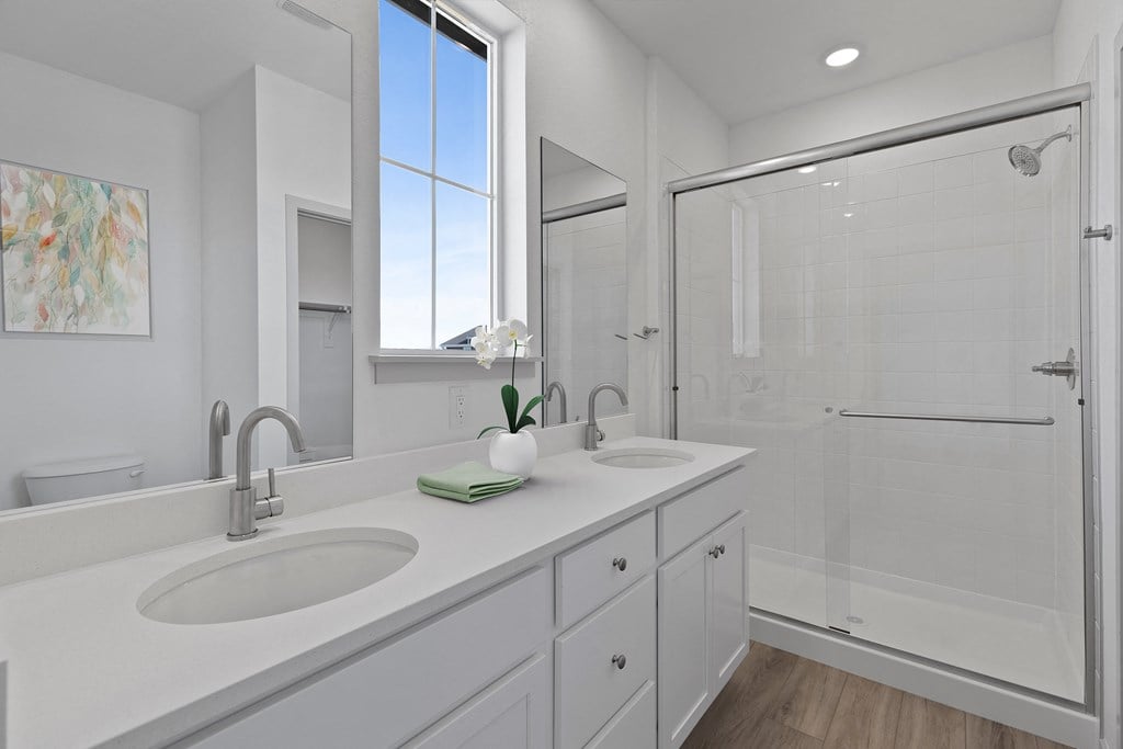 a white bathroom with two sinks and a shower  at Arrive Longmont, Longmont, Colorado