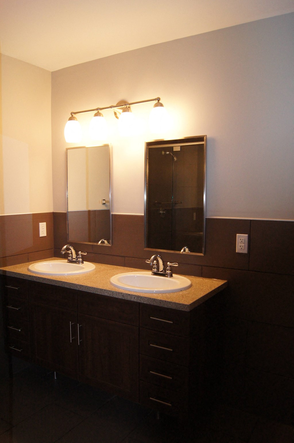 a bathroom with two sinks and two mirrors