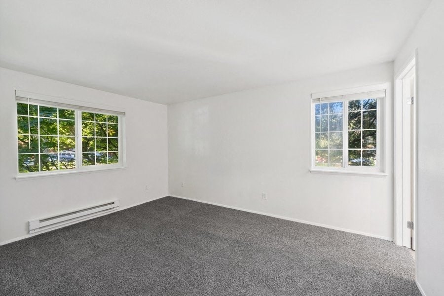 Room interior with two windows and carpeting