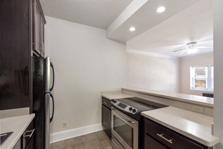 a kitchen with stainless steel appliances and a counter top