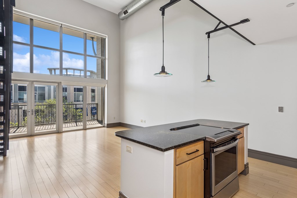 A kitchen with a black countertop and wooden cabinets.