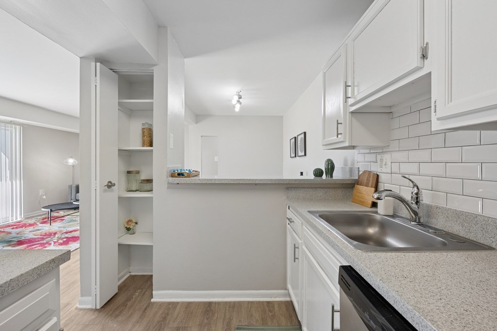 A kitchen with white cabinets and a countertop.
